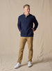 Men's Foothill V2 Placket in Indigo, full-length on-model lifestyle view featuring navy fleece fabric, three-button placket with gold suede trim, layered over a white polo, styled with khaki pants and white golf shoes