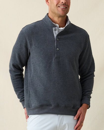Men's Foothill V2 Placket in Charcoal, front view on model featuring a charcoal heathered fleece pullover with snap button placket and mock collar, styled with a white collared shirt and light grey pants
