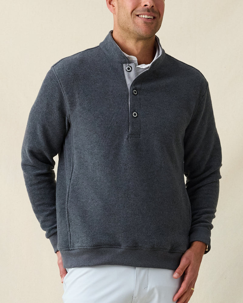 Men's Foothill V2 Placket in Charcoal, front view on model featuring a charcoal heathered fleece pullover with snap button placket and mock collar, styled with a white collared shirt and light grey pants