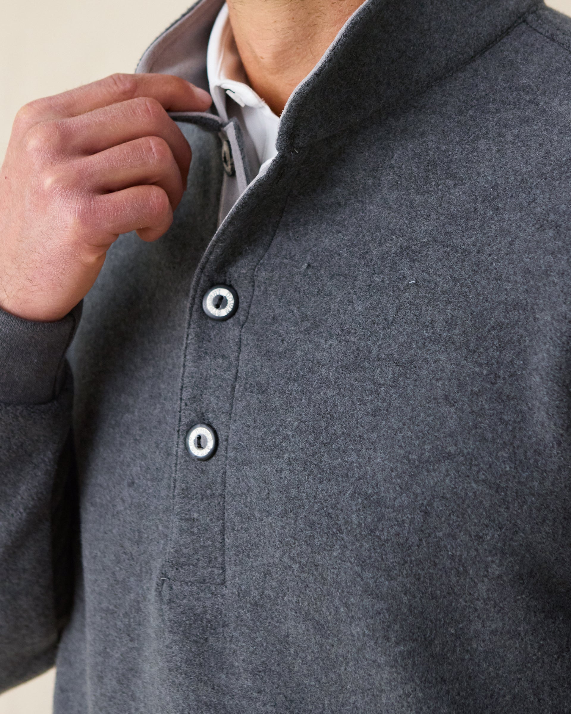 Men's Foothill V2 Placket in Charcoal, close-up detail view of the snap button placket and mock collar on charcoal heathered fleece, styled over a white collared shirt