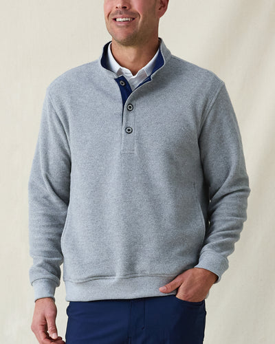 Men's Foothill V2 Placket in Heather, front view on model featuring a grey heathered fleece pullover with snap button placket and mock collar with navy interior, styled with a white collared shirt and navy pants