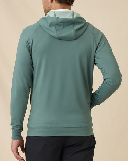 Back view of model wearing the Mackenzie Hoodie in Dark Forest, showing the relaxed hood and clean solid-color design.