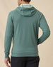Back view of model wearing the Mackenzie Hoodie in Dark Forest, showing the relaxed hood and clean solid-color design.