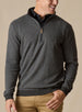 Men's Harrison Quarter Zip in Black, front model view featuring a charcoal herringbone knit body with ribbed cuffs and hem and quarter-zip closure with leather pull tab, layered over a black collared shirt with khaki pants