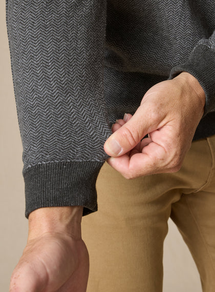 Men's Harrison Quarter Zip in Black, detail close-up view featuring a charcoal herringbone knit fabric with ribbed cuff detail, styled with khaki pants