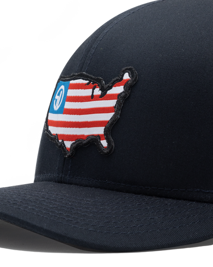Close-up of the United Hat's embroidered USA flag map patch with the Straight Down logo on the navy front panel.