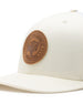 Straight Down SD Buffalo Strong Hat in Birch, close-up view showing brown leather Buffalo Strong circular patch detail on cream front panel