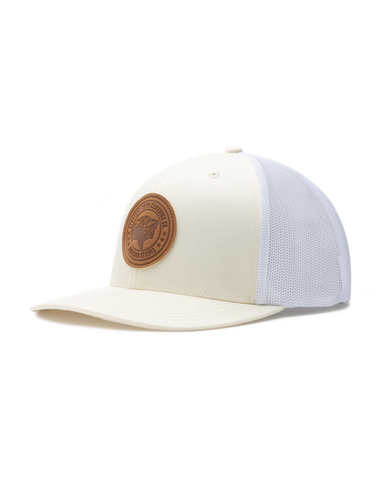 Straight Down SD Buffalo Strong Hat in Birch, angled view showing cream structured front panel with white mesh back and brown leather buffalo circular patch