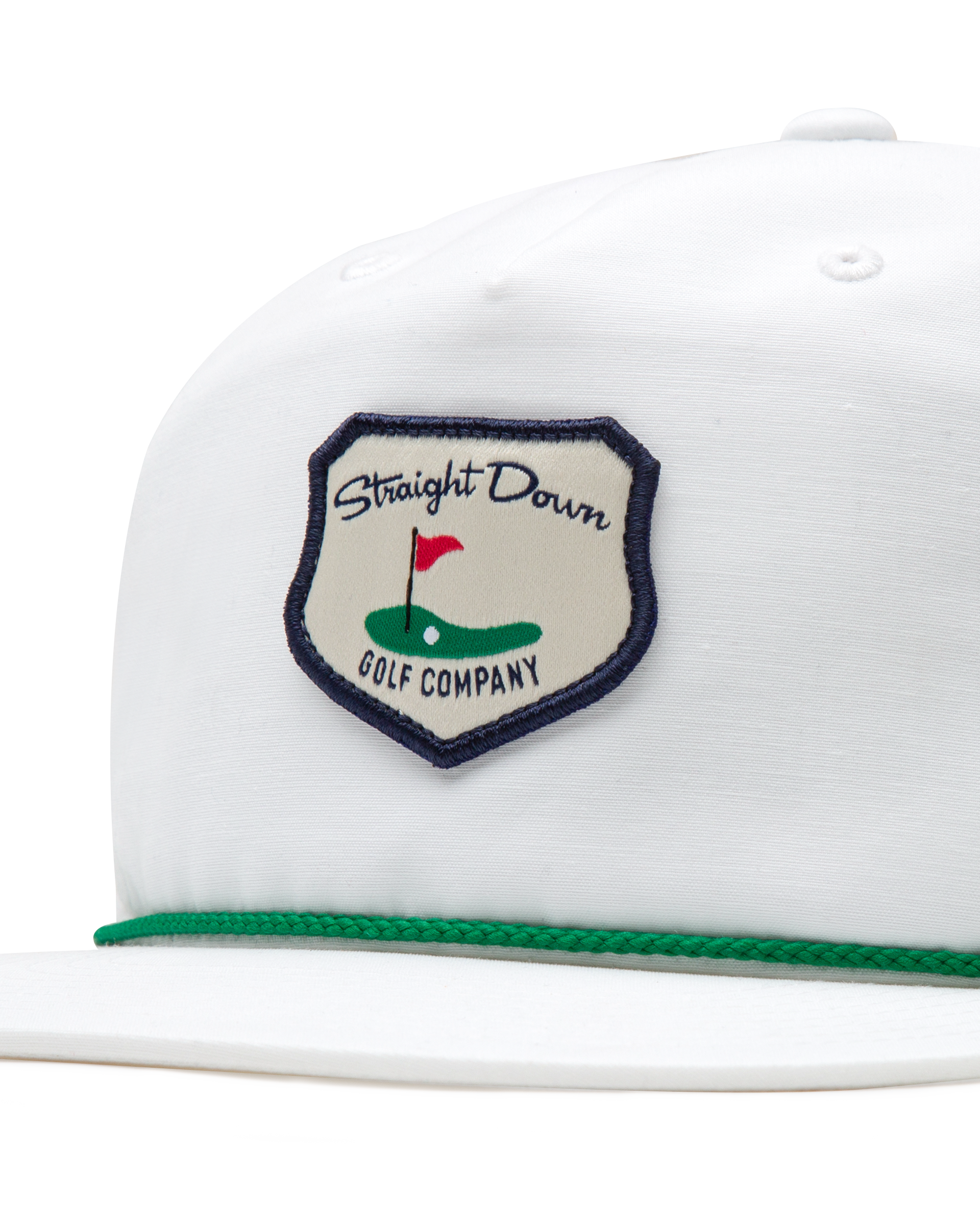 Hogan Retro Rope Hat in White, close-up front detail view highlighting the Straight Down Golf Company navy-bordered shield patch featuring a golf green with flag illustration, with green rope brim detail