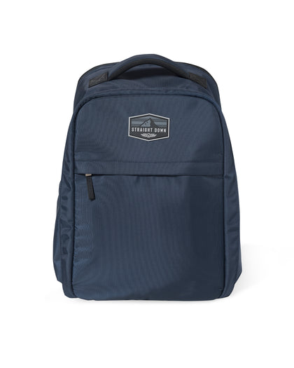 Straight Down Montana Backpack in New Indigo, front view featuring a navy ripstop nylon backpack with a Straight Down mountain badge logo patch, front zip pocket, and top carry handle