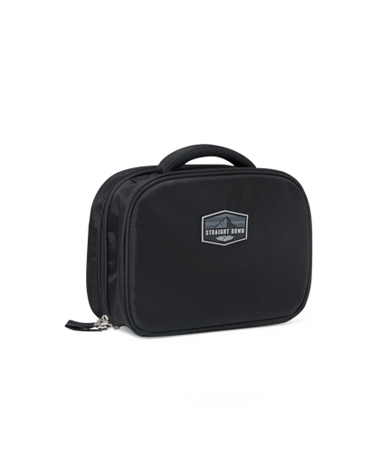 Straight Down Montana Dopp Bag in Black, front angle view featuring a black toiletry bag with a Straight Down mountain badge logo patch, zip closure, and top carry handle
