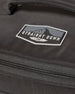 Straight Down Montana Cooler Bag in Black, close-up detail view highlighting the rubber Straight Down mountain badge logo patch on the black ripstop nylon exterior above the zip closure