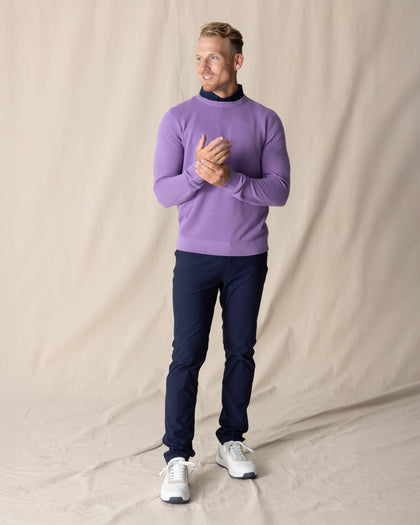 Men's Links Crewneck Sweater in Amethyst, full-length on-model view featuring a medium purple textured knit fabric with a crew neckline, styled with a navy collared shirt, navy pants, and white shoes