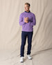 Men's Links Crewneck Sweater in Amethyst, full-length on-model view featuring a medium purple textured knit fabric with a crew neckline, styled with a navy collared shirt, navy pants, and white shoes