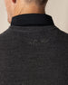 Men's Links Crewneck Sweater in Charcoal Heather, close-up detail view of the tonal embroidered Straight Down winged logo at the upper back against the dark heathered gray textured knit fabric, layered over a black collared shirt