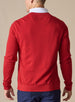 Men's Links Crewneck Sweater in Flag Red, back on-model view featuring a bold red textured knit fabric with a tonal embroidered Straight Down logo at the upper back, styled with a white collared shirt and navy pants