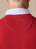 Men's Links Crewneck Sweater in Flag Red, close-up detail view of the tonal embroidered Straight Down winged logo at the upper back against the textured knit fabric, layered over a white collared shirt