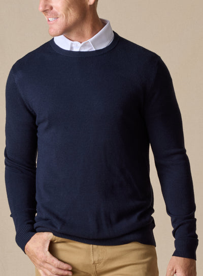Men's Links Crewneck Sweater in New Indigo, front on-model view featuring a navy textured knit fabric with a crew neckline, styled with a white collared shirt and tan pants