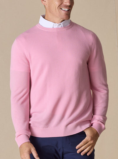 Men's Links Crewneck Sweater in Pink Lemonade, front on-model view featuring a soft pink textured knit fabric with a crew neckline, styled with a white collared shirt and navy pants
