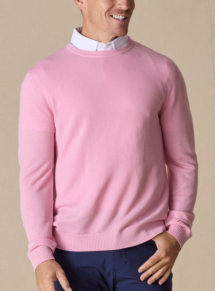 Men's Links Crewneck Sweater in Pink Lemonade, front on-model view featuring a soft pink textured knit fabric with a crew neckline, styled with a white collared shirt and navy pants
