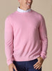 Men's Links Crewneck Sweater in Pink Lemonade, front on-model view featuring a soft pink textured knit fabric with a crew neckline, styled with a white collared shirt and navy pants