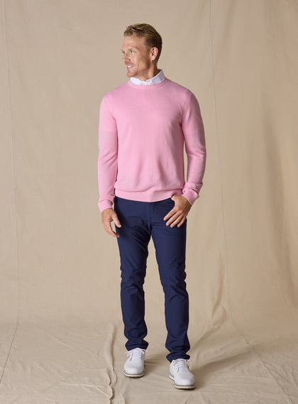 Men's Links Crewneck Sweater in Pink Lemonade, full-length on-model view featuring a soft pink textured knit fabric with a crew neckline, styled with a white collared shirt, navy pants, and white shoes