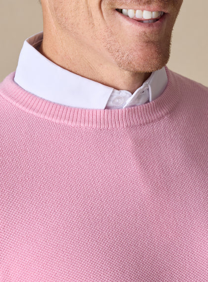 Men's Links Crewneck Sweater in Pink Lemonade, close-up detail view of the ribbed crew neckline and textured knit fabric, layered over a white collared shirt