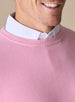 Men's Links Crewneck Sweater in Pink Lemonade, close-up detail view of the ribbed crew neckline and textured knit fabric, layered over a white collared shirt
