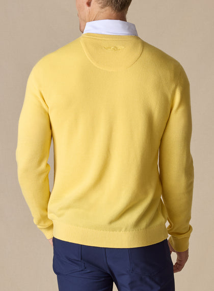 Men's Smithson Links Crewneck Sweater in Sunshine, back model view featuring a yellow textured knit body with ribbed cuffs and hem, tonal logo embroidery at the upper back, styled over a white collared shirt with navy pants