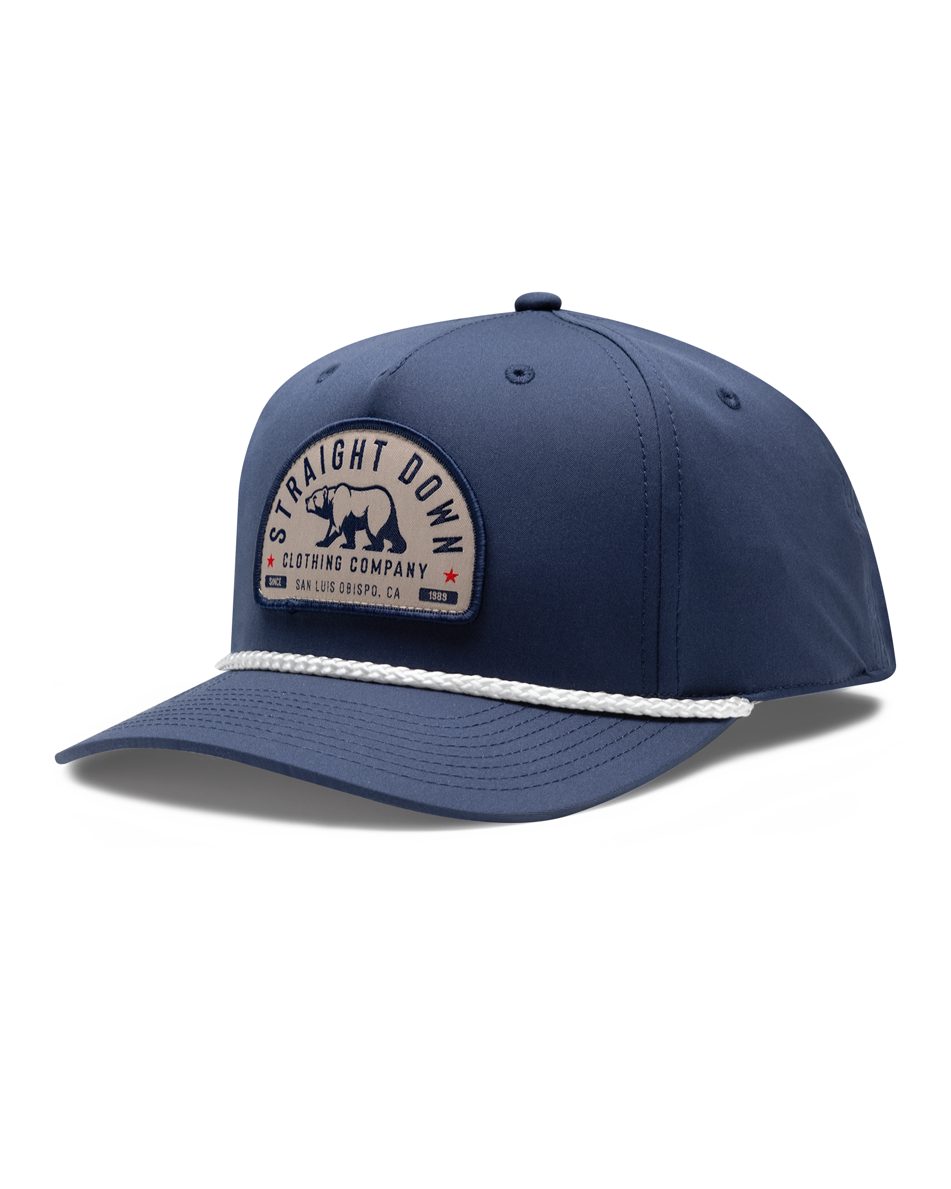 Bear Country Rope Hat in New Indigo, side view featuring a navy structured cap with a woven bear patch reading 