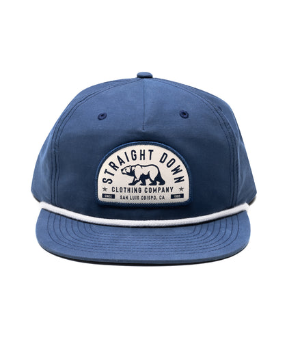 Bear Country Rope Hat in New Indigo, front view featuring a cream and navy arched Straight Down Clothing Company bear patch on the front panel with a white rope detail along the brim