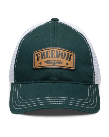 Freedom Hat in Green, front view featuring a forest green structured trucker cap with a leather patch reading "Freedom" and Straight Down logo on the front panel, white mesh back panels, and white contrast stitching on the brim