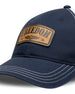 Freedom Hat in Navy, close-up front view featuring a tan leather patch reading "Freedom" with the Straight Down logo and star accents, white contrast stitching detail on the navy structured brim