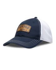 Freedom Hat in Navy, side view featuring a navy and white mesh trucker hat with a leather "Freedom" and Straight Down logo patch on the front panel with white contrast stitching