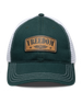 Freedom Hat in Green, front view featuring a green structured trucker cap with white mesh back panels, white contrast stitching on the brim, and a tan leather patch reading "Freedom" with the Straight Down logo and star accents centered on the front panel