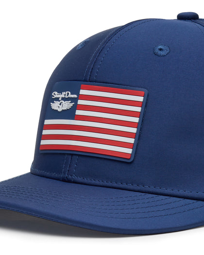 Republic Hat in New Indigo, close-up front detail view featuring a red, white, and blue American flag rubber patch with Straight Down script logo and winged logo on the navy front panel