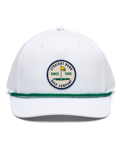 Pin High Rope Hat in White Kelly, front view featuring a Straight Down Golf Company circular patch depicting a golf hole with a yellow flag, "Since 1989" text, on a white hat with a green rope brim detail