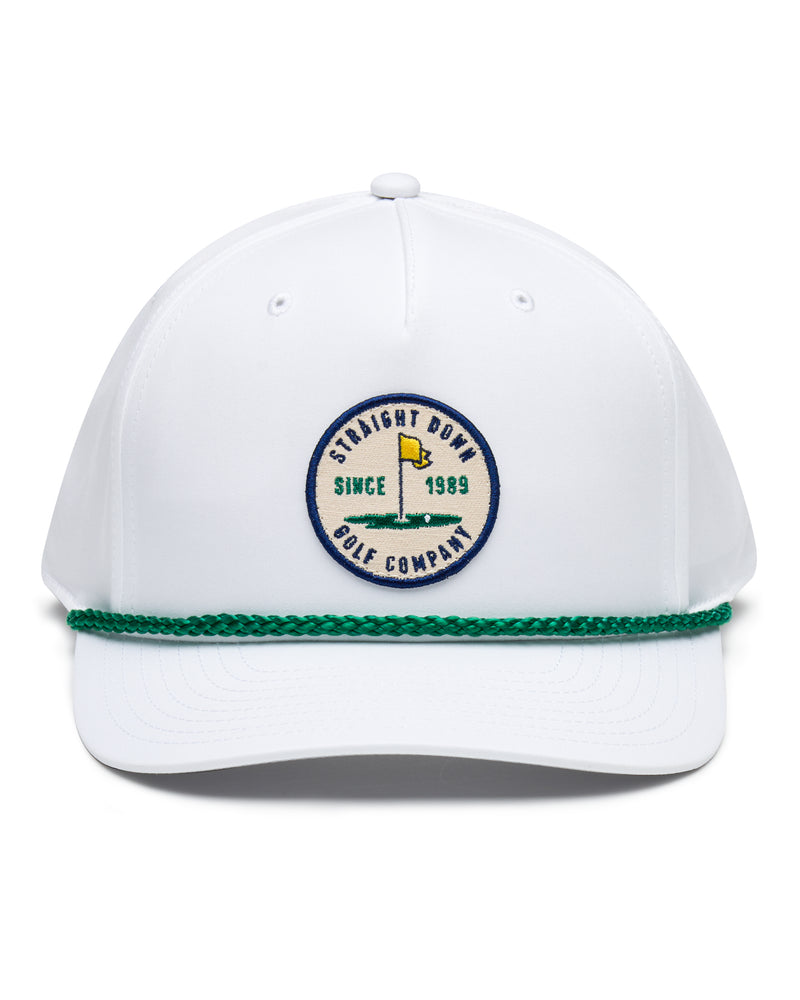 Pin High Rope Hat in White Kelly, front view featuring a Straight Down Golf Company circular patch depicting a golf hole with a yellow flag, "Since 1989" text, on a white hat with a green rope brim detail