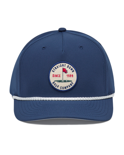 Pin High Rope Hat in Navy, front view featuring a Straight Down Golf Company circular patch depicting a golf hole with a red flag and "Since 1989" text, on a navy hat with a white rope brim detail