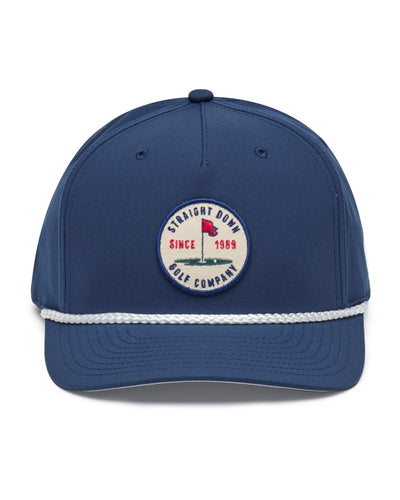 Pin High Rope Hat in Navy, front view featuring a Straight Down Golf Company circular patch depicting a golf hole with a red flag and "Since 1989" text, on a navy hat with a white rope brim detail