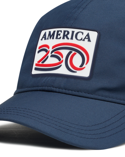 A navy structured baseball cap with a curved brim, featuring a front patch that reads 'AMERICA 250' in navy, red, and white.