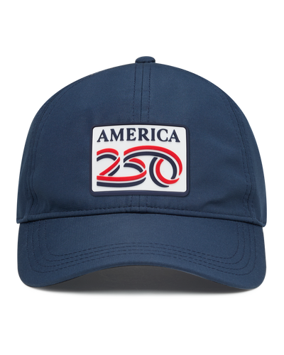 A navy structured baseball cap with a curved brim, featuring a front patch that reads 'AMERICA 250' in navy, red, and white. The cap has perforated side panels for ventilation.