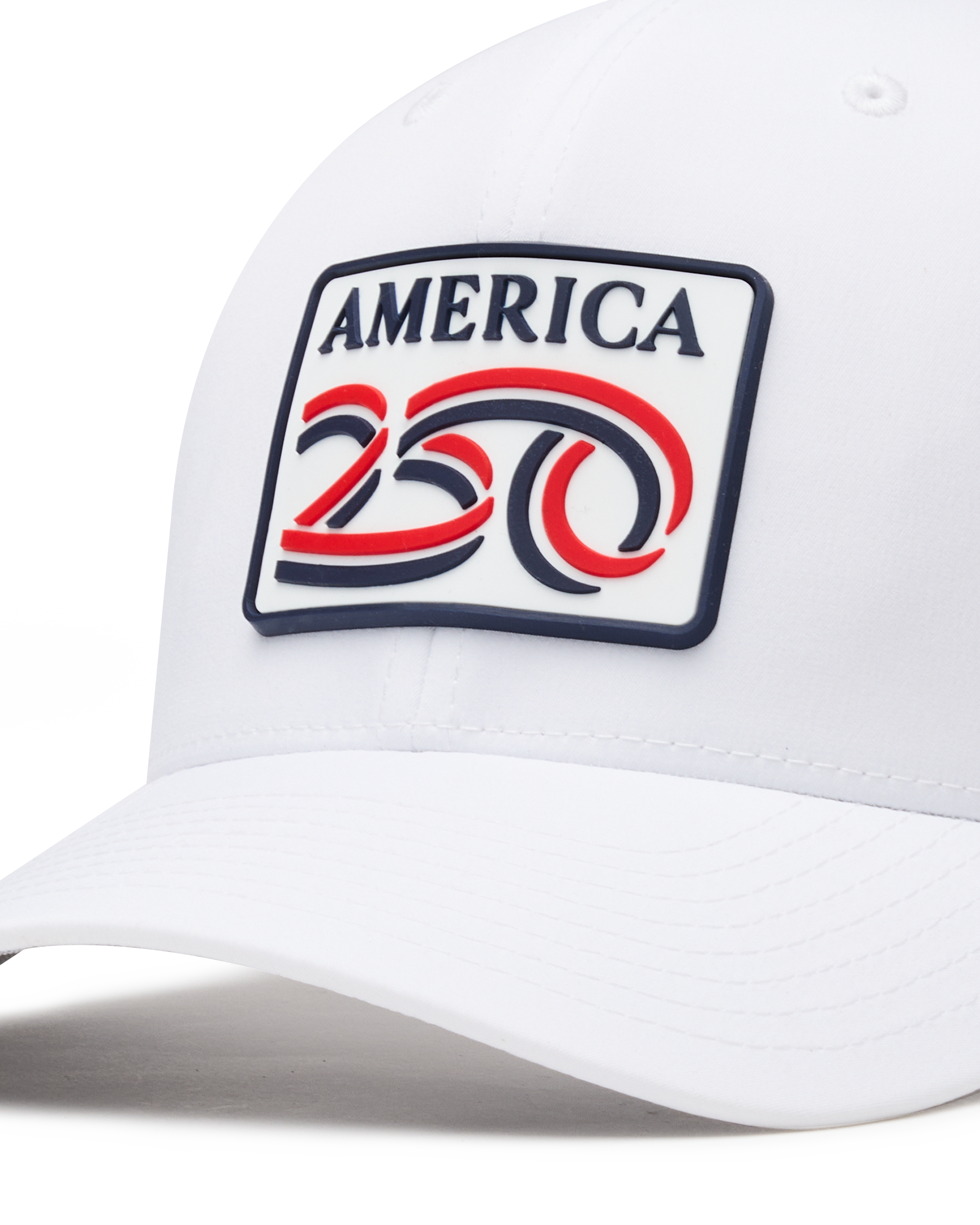 Detail shot of a white structured baseball cap with a curved brim, featuring a front patch that reads 'AMERICA 250' in navy, red, and white. The cap has perforated side panels for ventilation.
