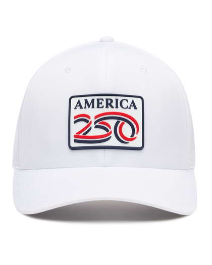 A white structured baseball cap with a curved brim, featuring a front patch that reads 'AMERICA 250' in navy, red, and white. The cap has perforated side panels for ventilation.