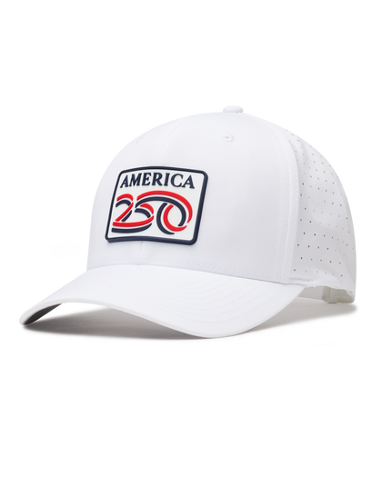 A white structured baseball cap with a curved brim, featuring a front patch that reads 'AMERICA 250' in navy, red, and white. The cap has perforated side panels for ventilation.