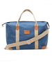 Weekender Bag in Moonlight, front product view featuring a blue waxed canvas body with tan canvas handles, tan leather trim accents, adjustable shoulder strap, and Straight Down logo patch