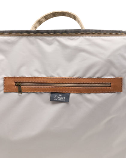 Weekender Bag in Moonlight, interior detail view showcasing the light grey lining with a tan leather-trimmed interior zip pocket and Coast New Zealand label
