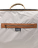 Weekender Bag in Moonlight, interior detail view showcasing the light grey lining with a tan leather-trimmed interior zip pocket and Coast New Zealand label