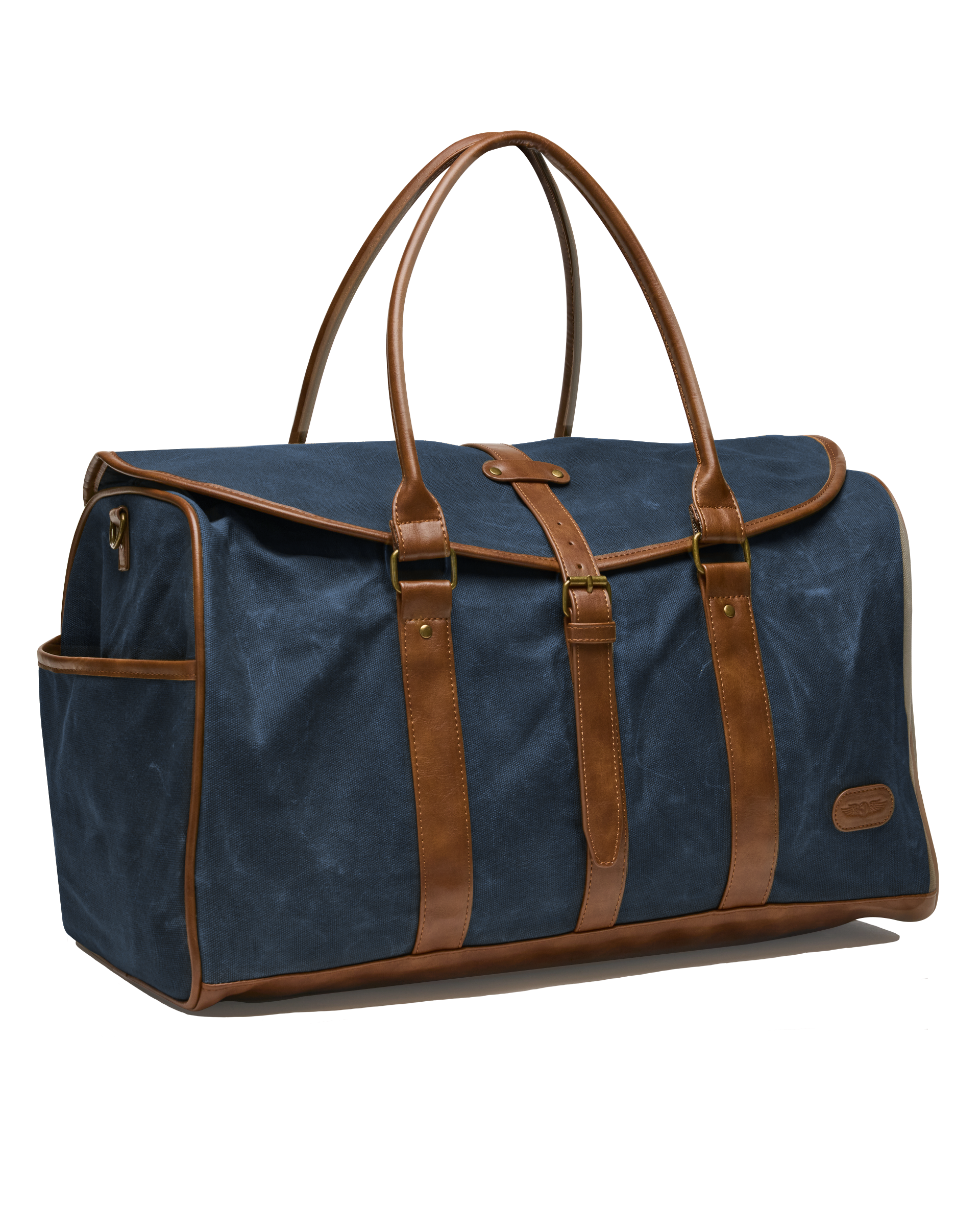 Angled view of the navy waxed canvas duffle bag, showcasing its structured shape, brown leather detailing, brass buckle closure, and exterior side pocket.