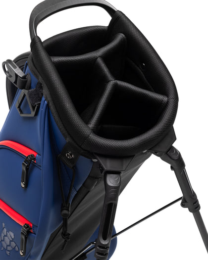 Straight Down Lux Carry Stand Bag in Navy Red, top-down view featuring 4-way black divided club organizer top, padded black carry handle, deployed kickstand legs, and red zipper accent pocket detail